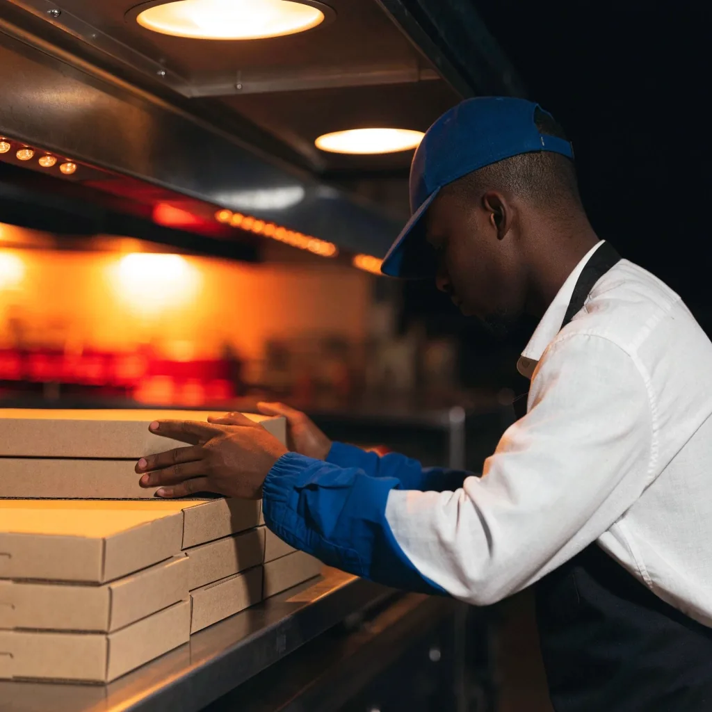 Pizzas waiting on the pickup shelf under heat lamps